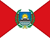 Red triangles on fly and hoist sides and white triangles on top and below and national emblem in the middle
